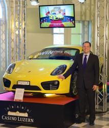 Philipp Albrecht, Marketing Manager des Grand Casino Luzern, mit dem neuen Porsche Cayman S 2013, der im Foyer des Grand Casino Luzern im Auto Jackpot zu gewinnen ist.