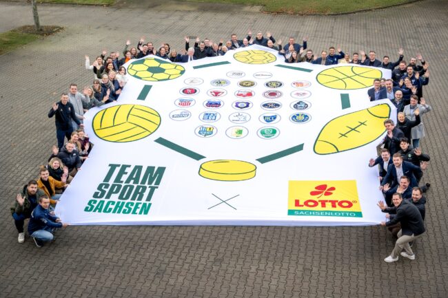 Das besondere Mannschaftsfoto: Sachsenlotto-Mitarbeiter präsentieren gemeinsam mit Vertretern der TeamSportSachsen-Vereine ein großflächiges Motiv der Kooperation. (Foto: Klaus Trotter)