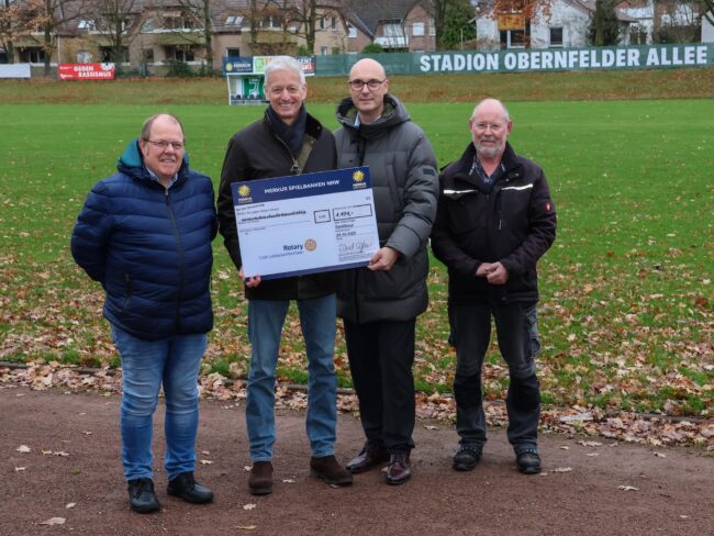 Im Stadion Obernfelder Allee übergeben Dietrich von der Recke (Zweiter von links) und David Schnabel (Zweiter von rechts) den Spendenscheck an Wolfgang Ulrichs (links) und Gerhard Blase. (Foto: Merkur Group)